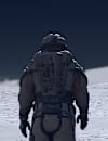 A person in a spacesuit walks towards a planet looming in the background.